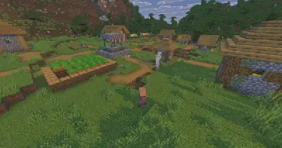 A Minecraft village with houses, paths and farmland