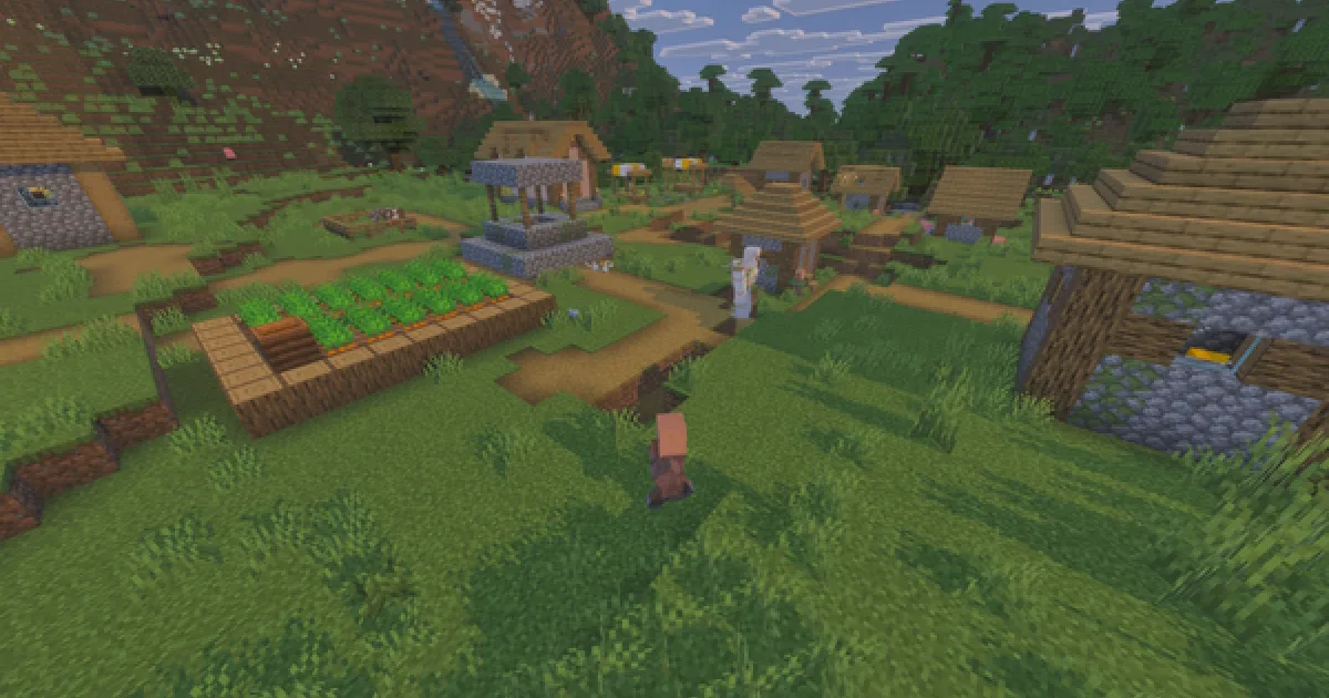 A Minecraft village with houses, paths and farmland